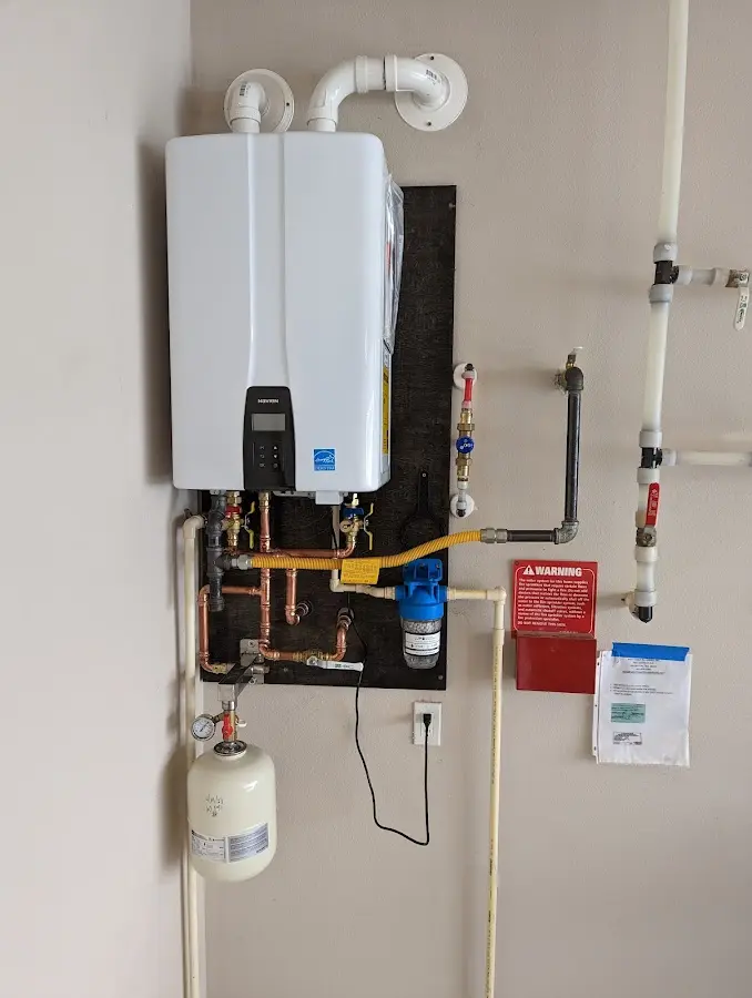 Professional plumber installing copper piping in a West Hartford home